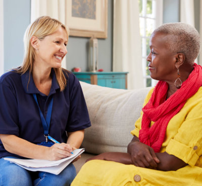 caregiver and a senior woman having a conversation