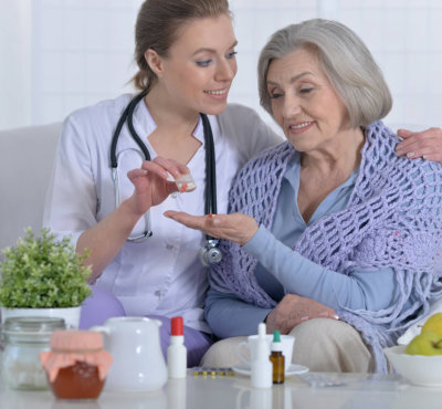 nurse giving her patient her medication