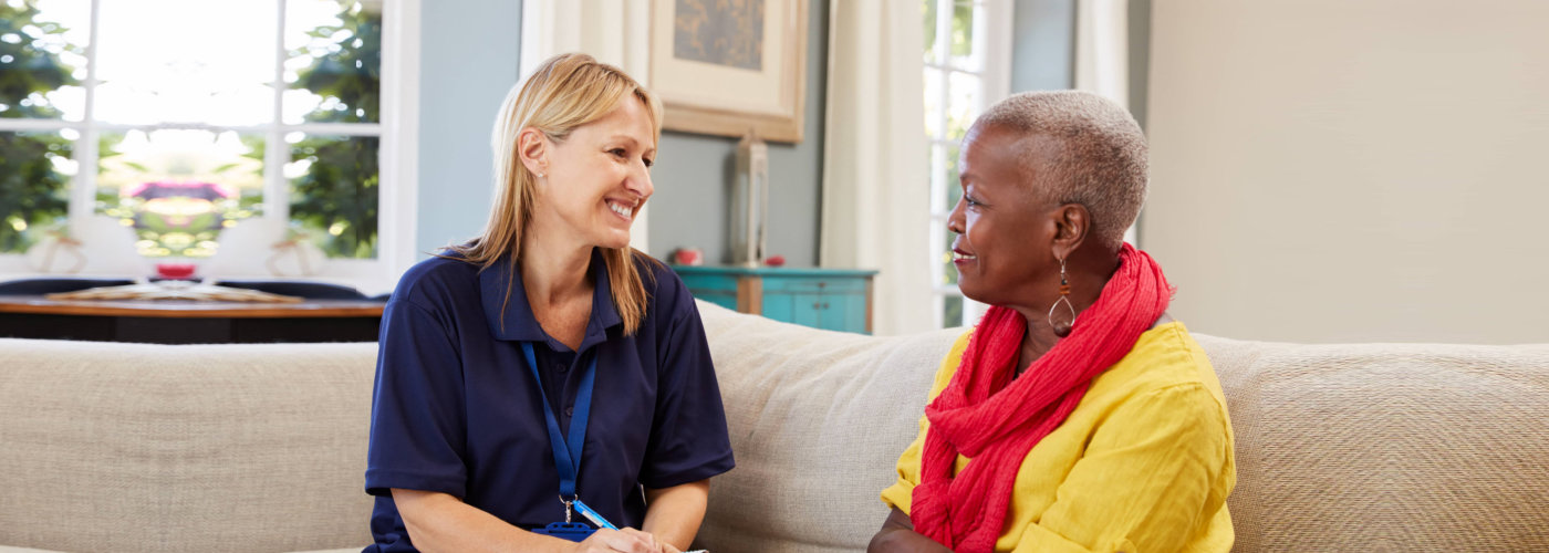 caregiver and a senior woman having a conversation